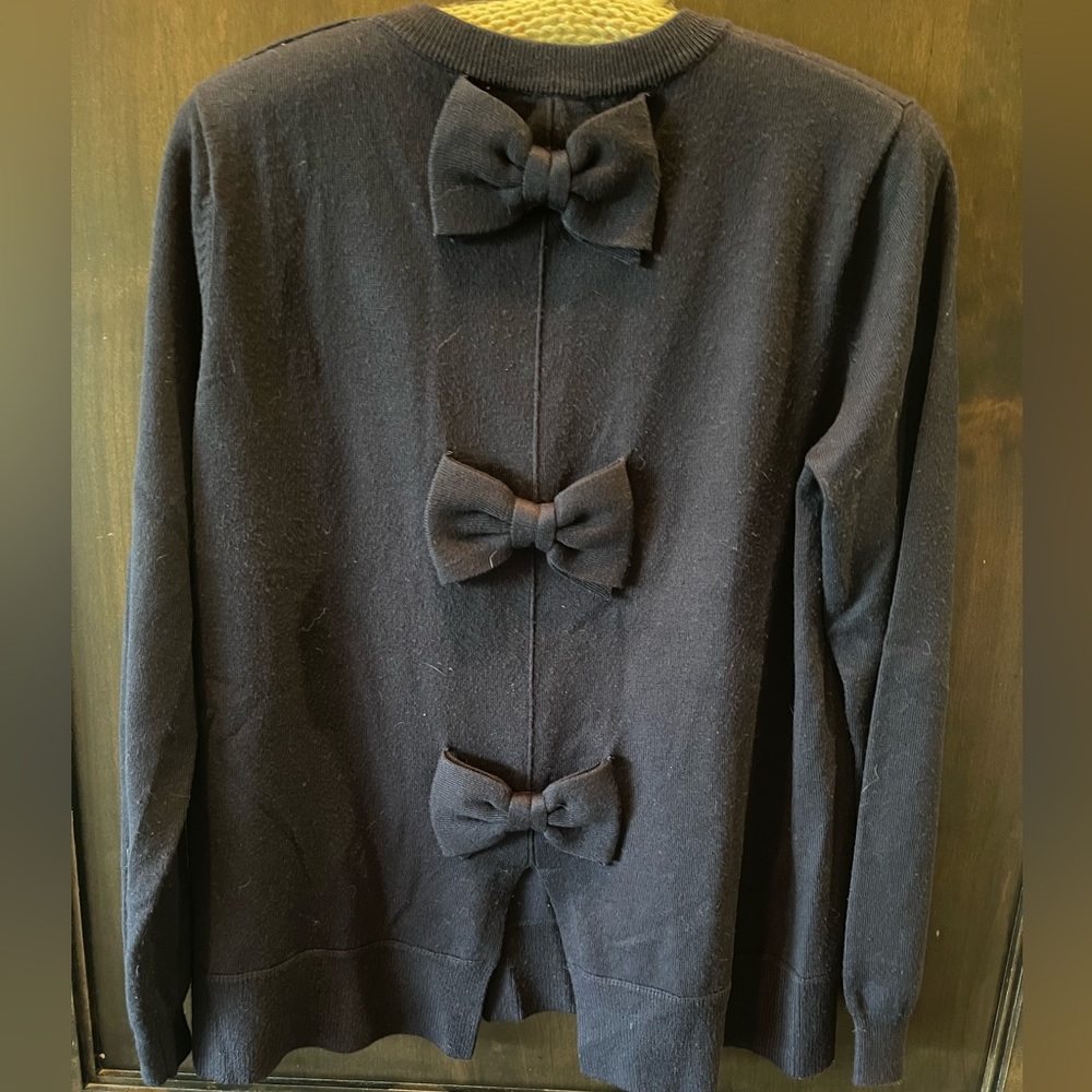 Navy sweater with bow detail down back